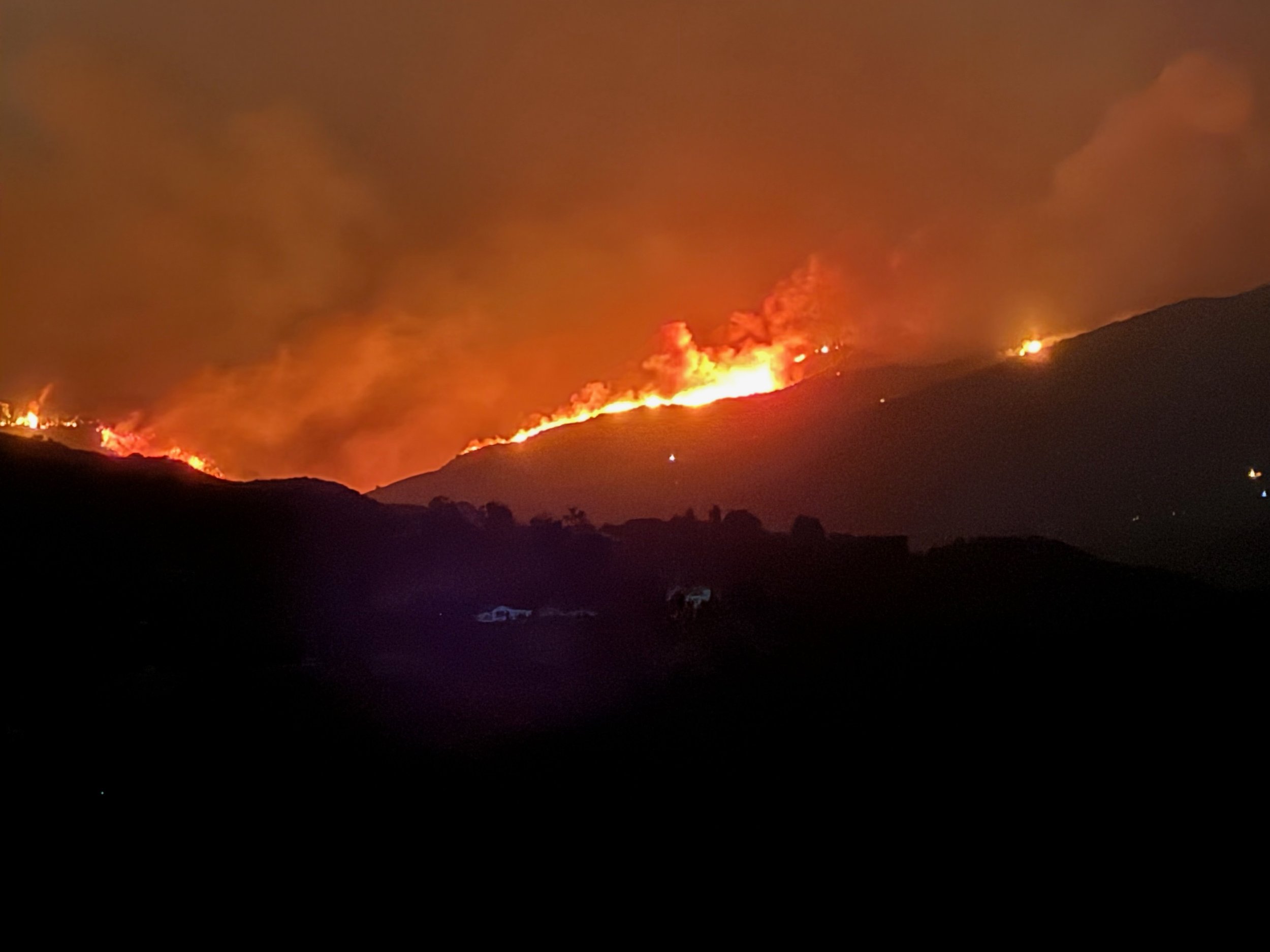 A photo of the Pacific Palisades fire moving across the ridgeline, from the vantage point of Old Topanga Canyon