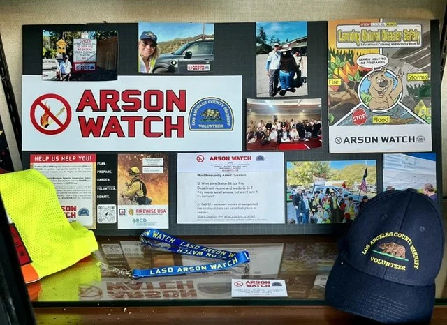 Arson Watch display of various gear, signage and photos  in the Topanga Community Library window