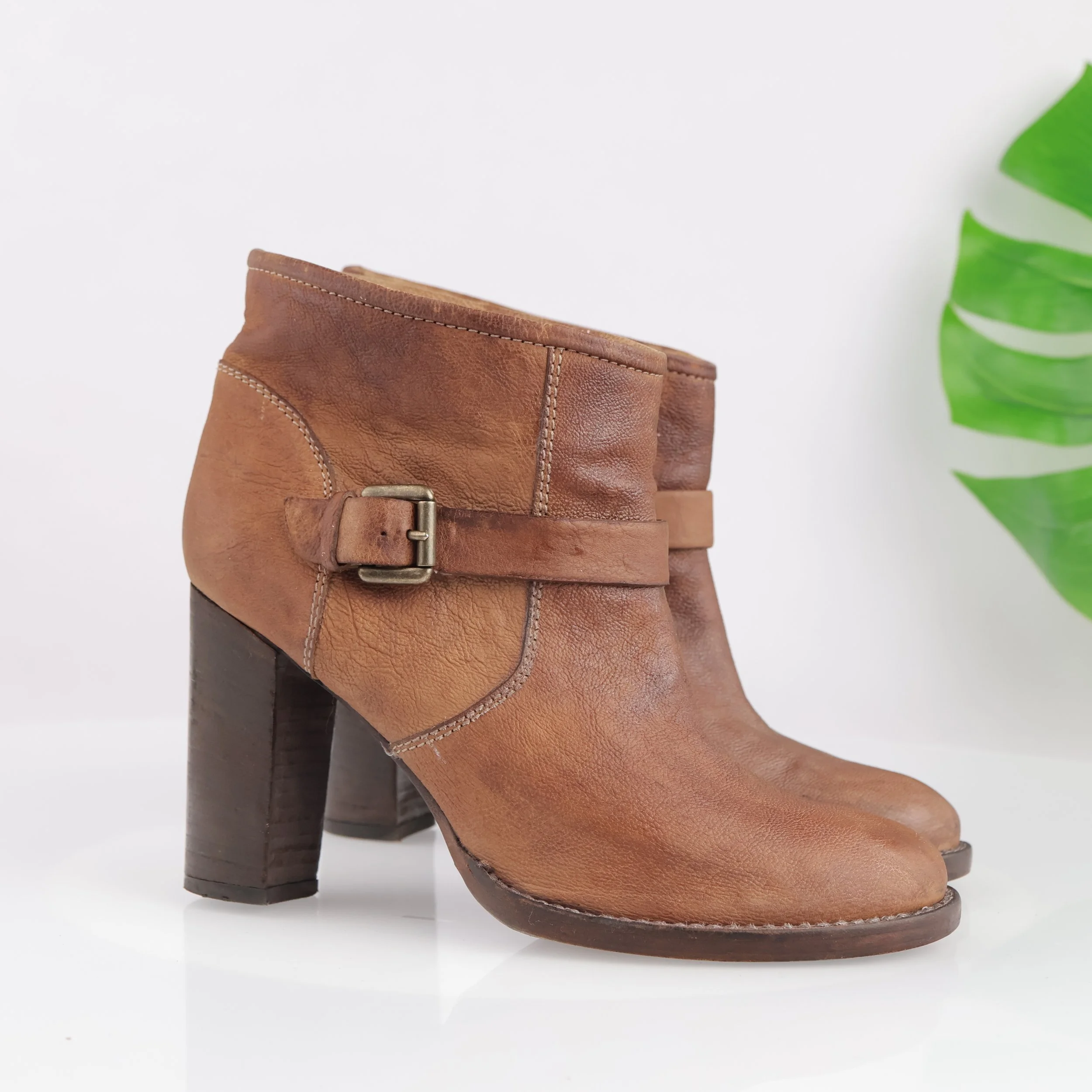 Brown ankle boot with heel and buckle. 