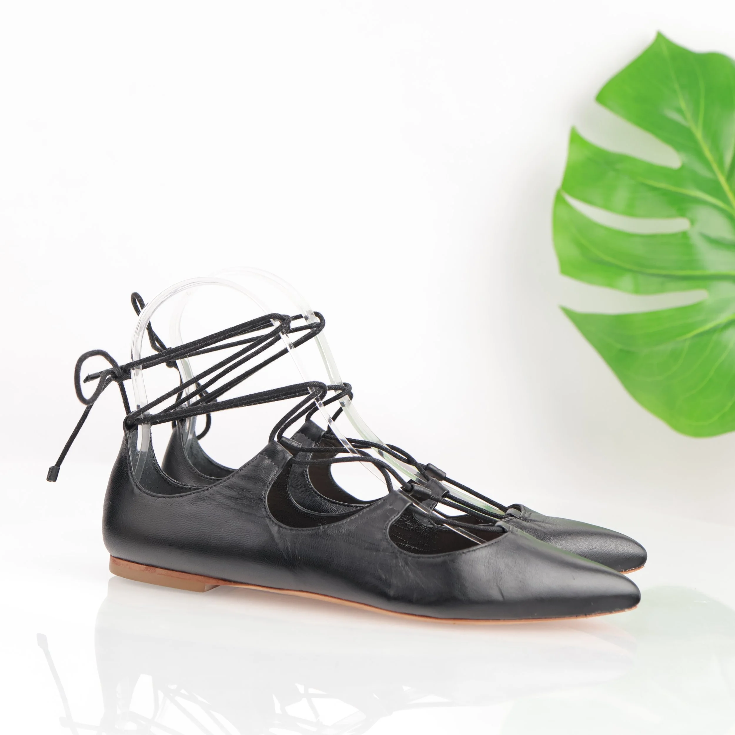 Black strappy lace-up flats.