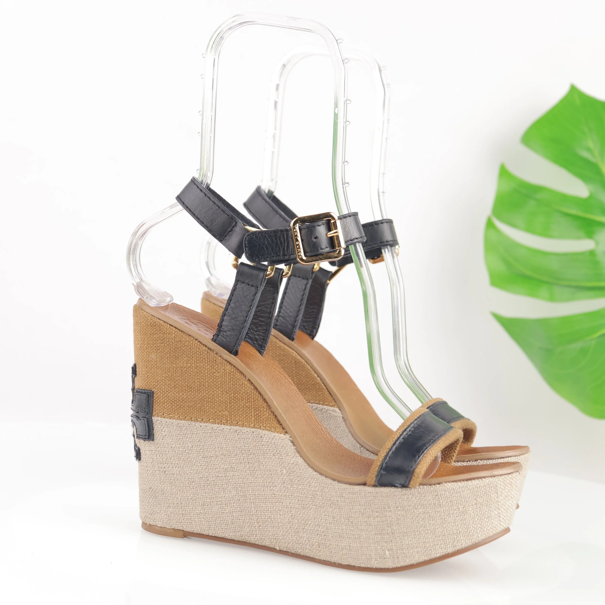 Tan wedge sandal with black ankle straps.