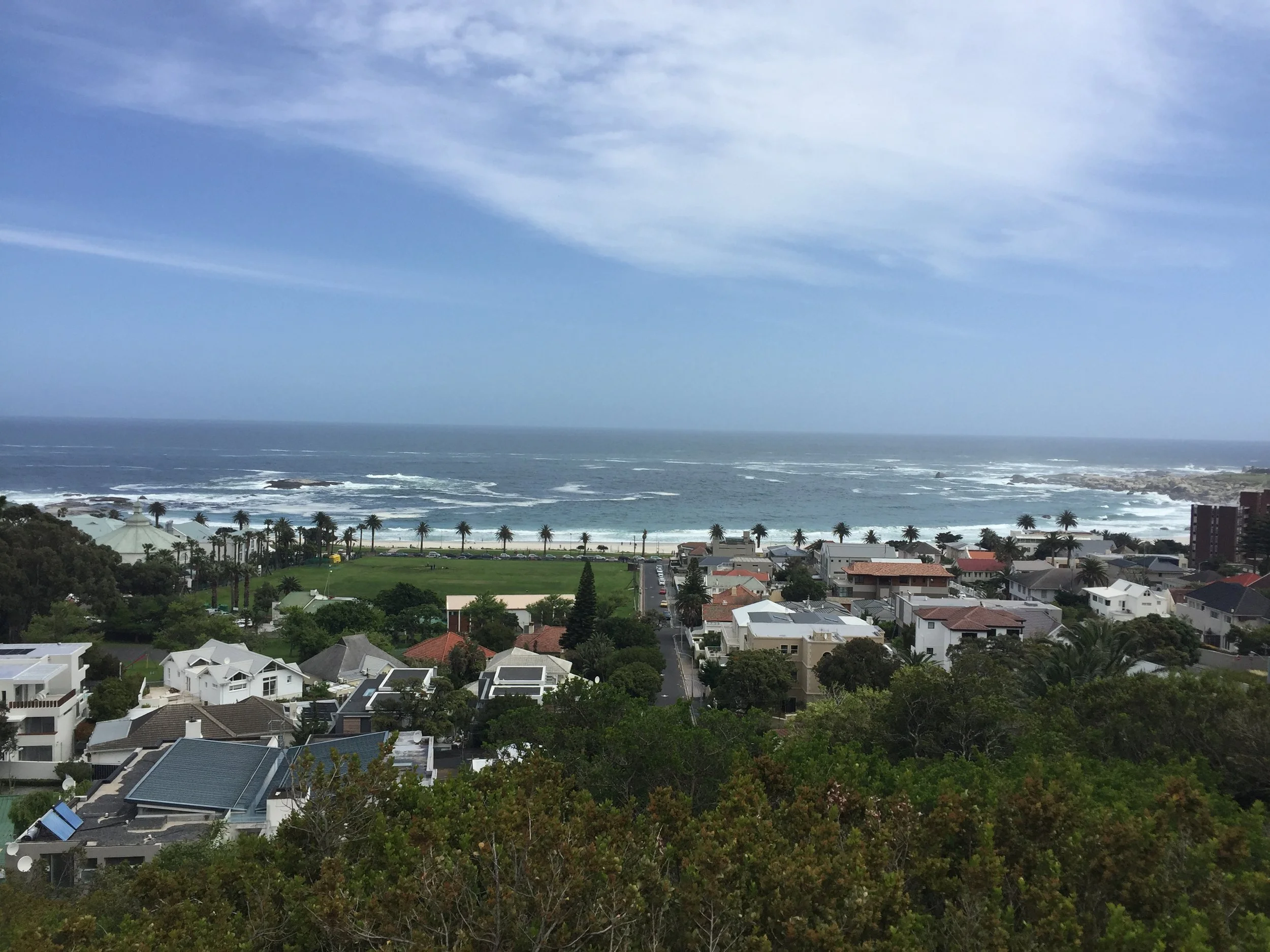 Coastal neighborhood and waves along the South African shore.