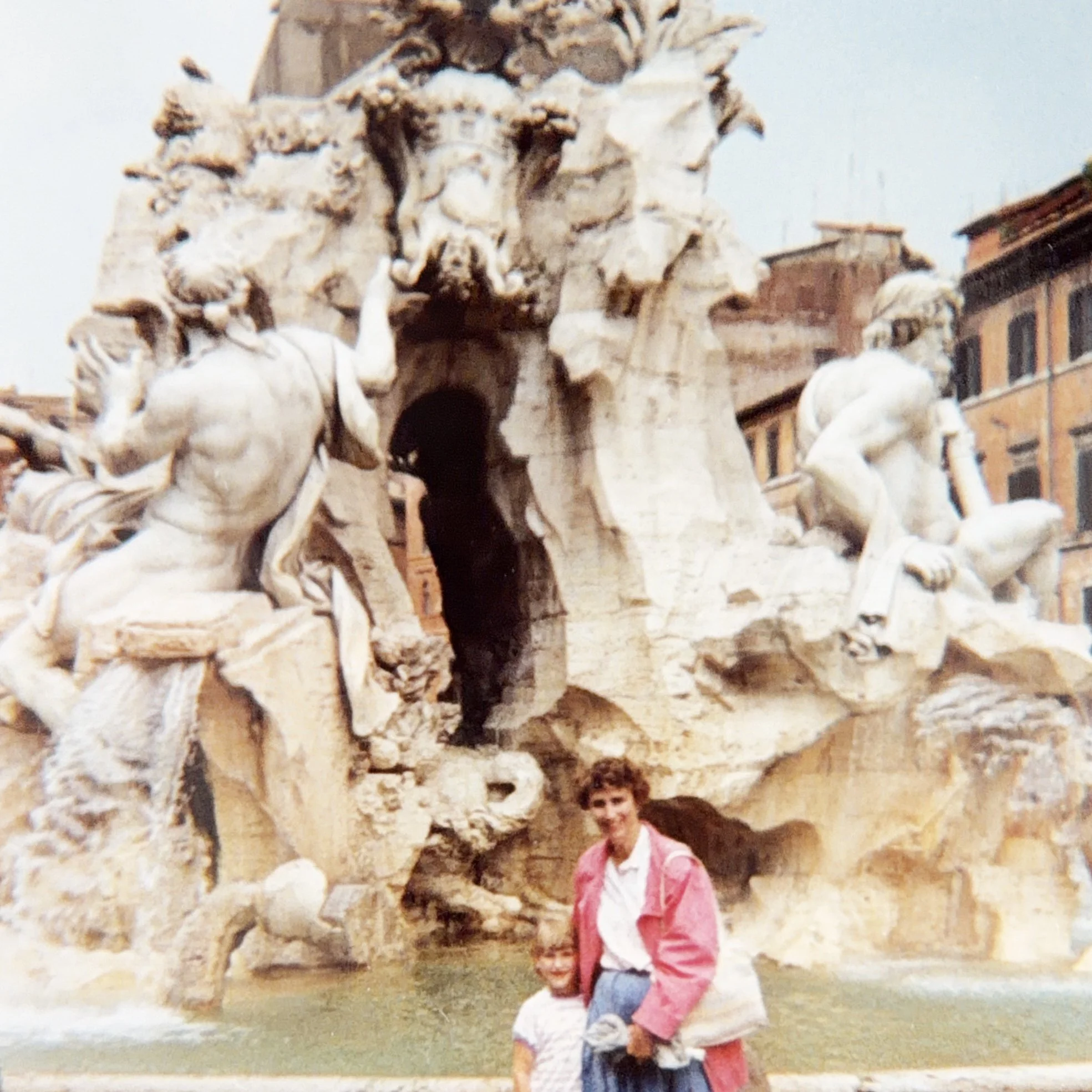 Mother and daughter posing in front of the Fontana dei Quattro Fiumi in Rome.
