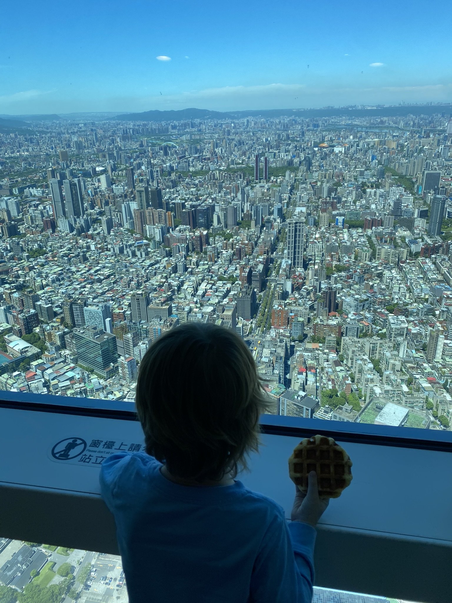1. A child looking out over Taipei’s skyline from the Taipei 101 observation deck.
