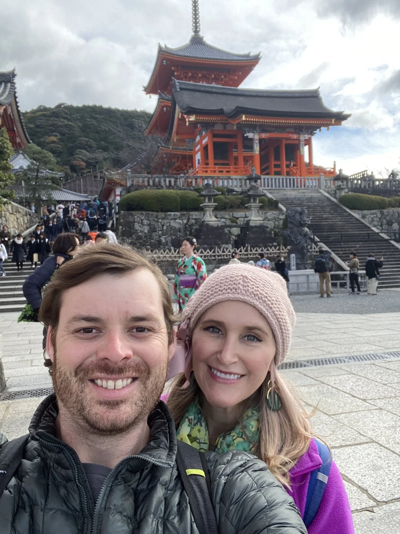 Couple taking a selfie in front of Kiyomizu-dera Temple in Kyoto, Japan.