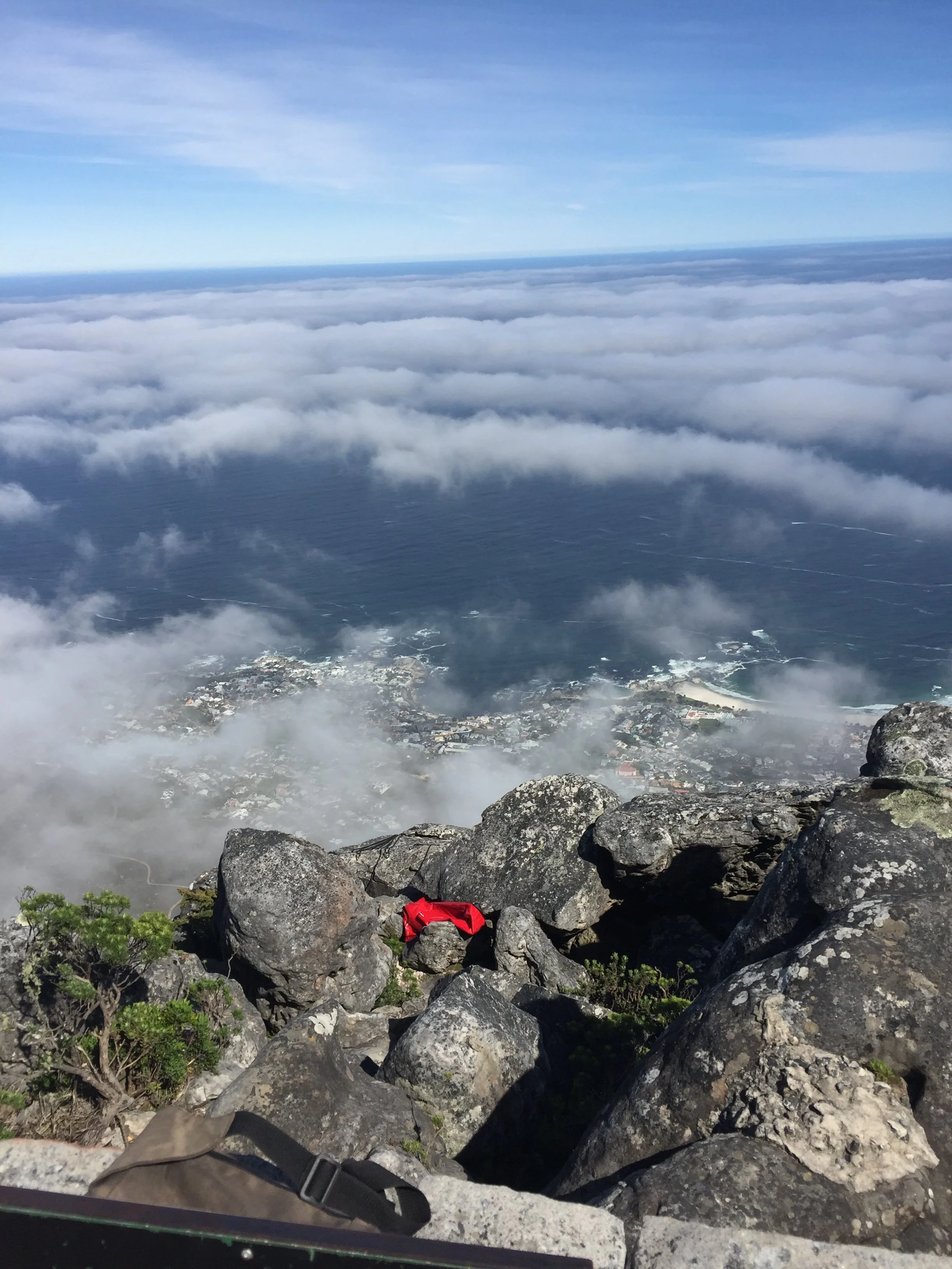 Clouds rolling over Cape Town and the coast, viewed from Table Mountain.