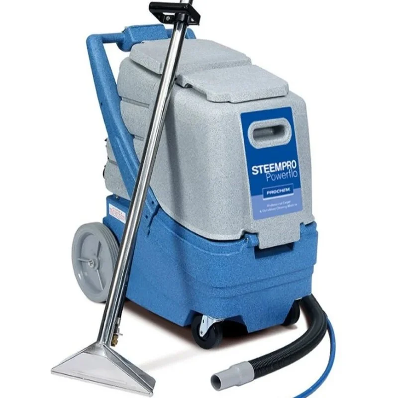 A portable carpet cleaning machine with a grey body, blue base, and a long metal wand with a cleaning head, on white background.