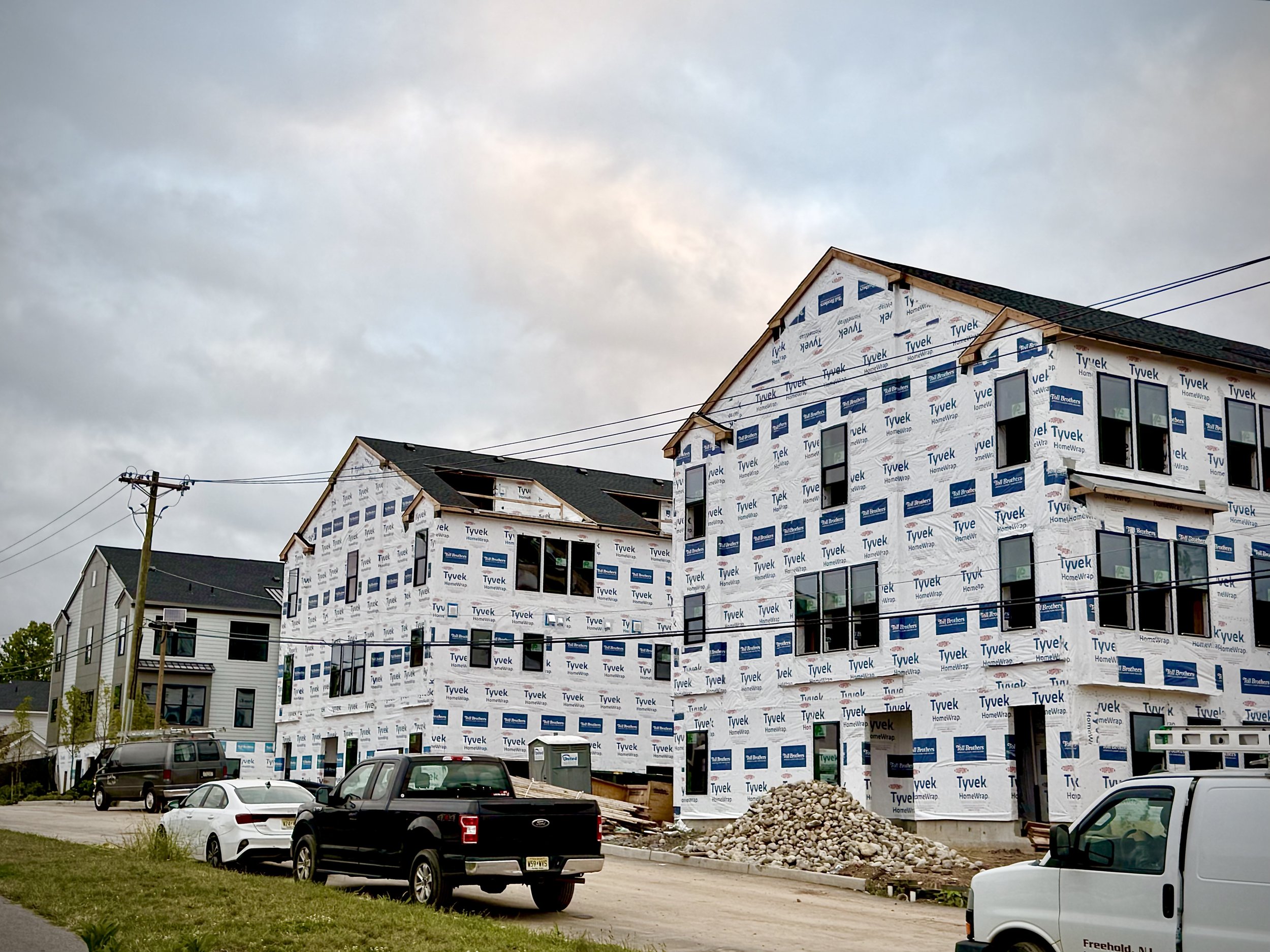 Townhomes under construction at Magnolia Square, wrapped in house wrap with no siding installed