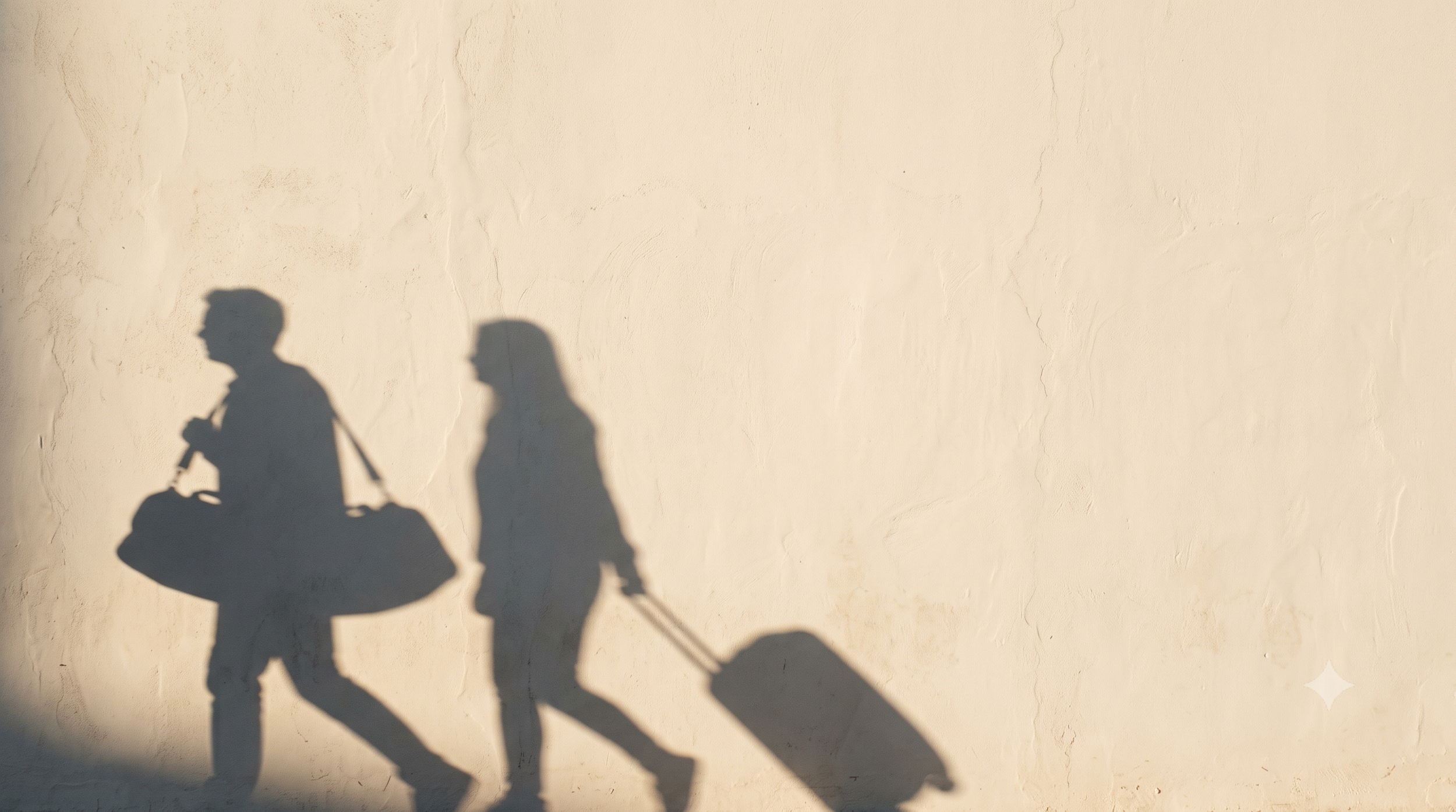 Travellers carrying luggage in warm afternoon light