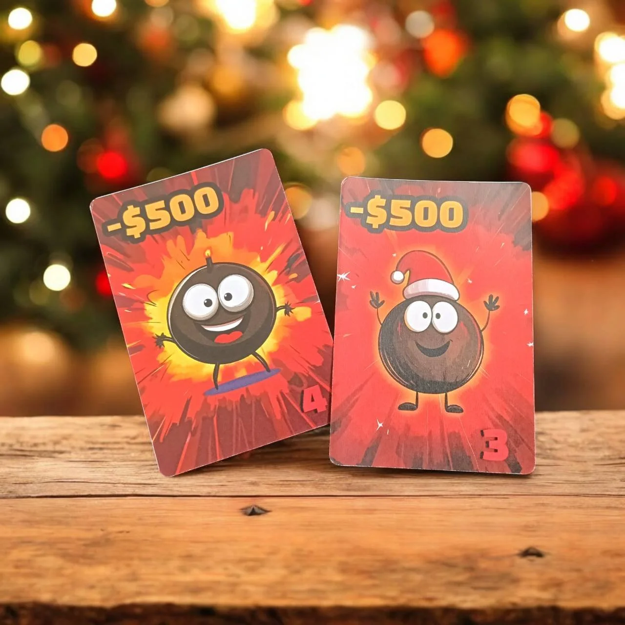 Two cards with cartoon bombs, both labeled -$500. The left bomb has a wide smile and is standing on a skateboard, and the right bomb is wearing a Santa hat, with arms raised, both cards are set against a blurred Christmas tree background.
