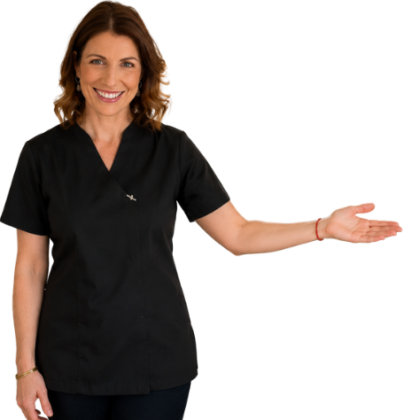Ruth Blair from In-Tune Reflexology smiling and pointing with her left arm extended.