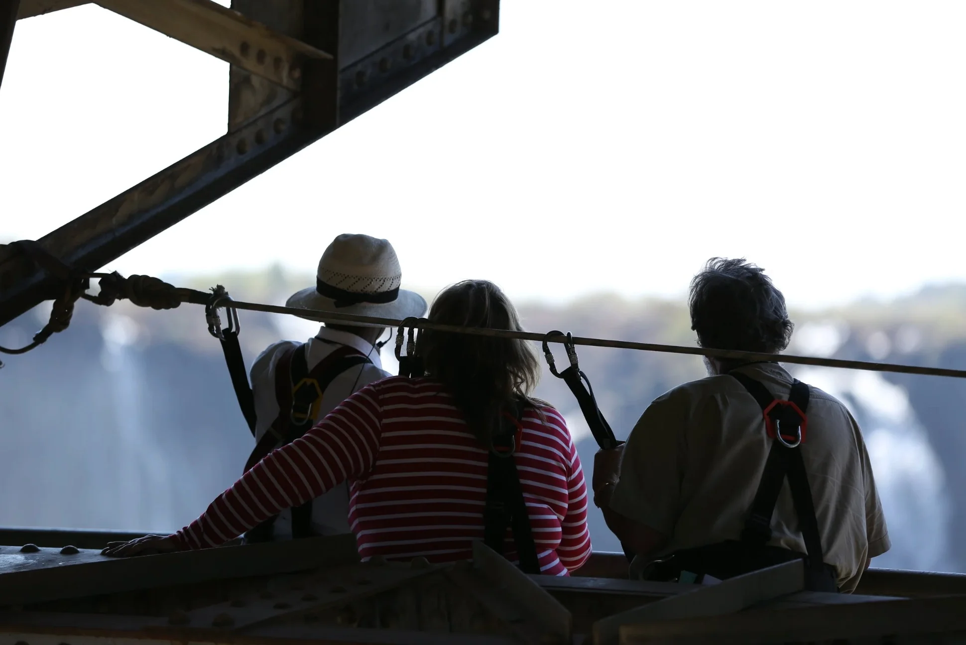 Group of three people on a victoria falls bridge tour