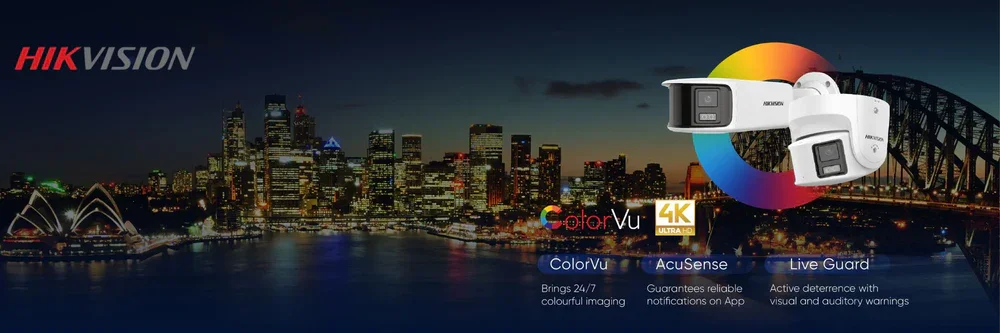 Night city skyline with illuminated buildings, Sydney Opera House, and Harbour Bridge, overlaid with advertisements for Hikvision security cameras and technology features like ColorVu, 4K Ultra HD, AcuSense, and Live Guard.