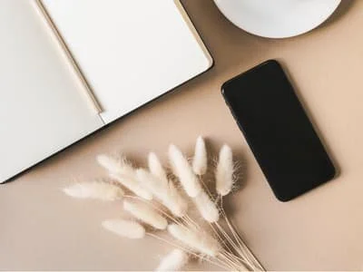 Innerbloom Studio phone on desk showcasing free consultation for web design services.