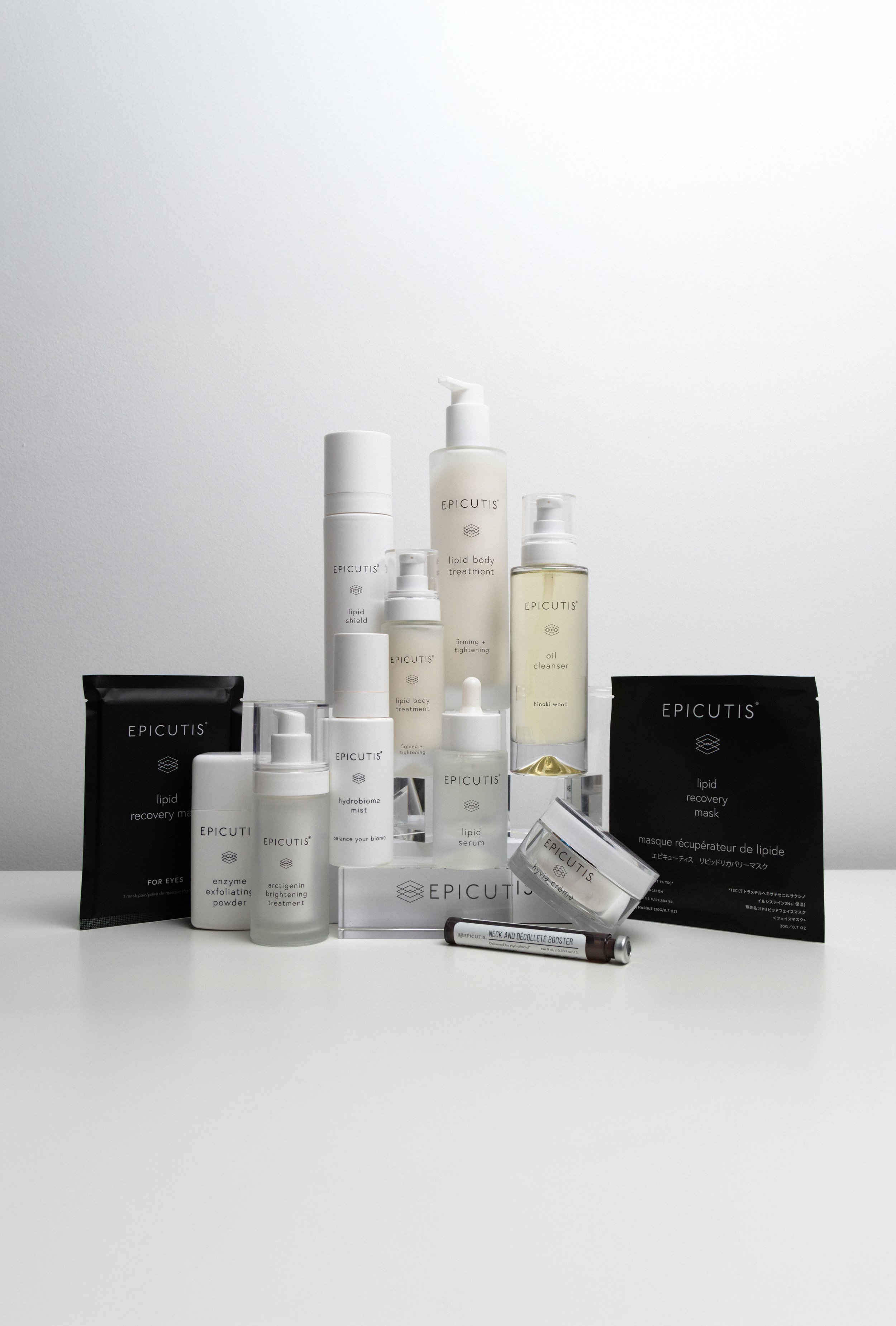 Collection of skincare and beauty products from Epictus, including serums, masks, and sprays, arranged on a white surface with a plain white background.