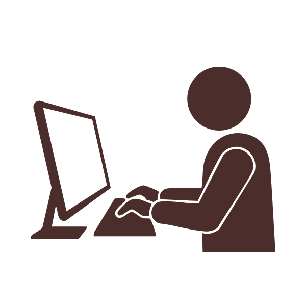 Silhouette of a person sitting at a desk, typing on a computer keyboard with a monitor in front.