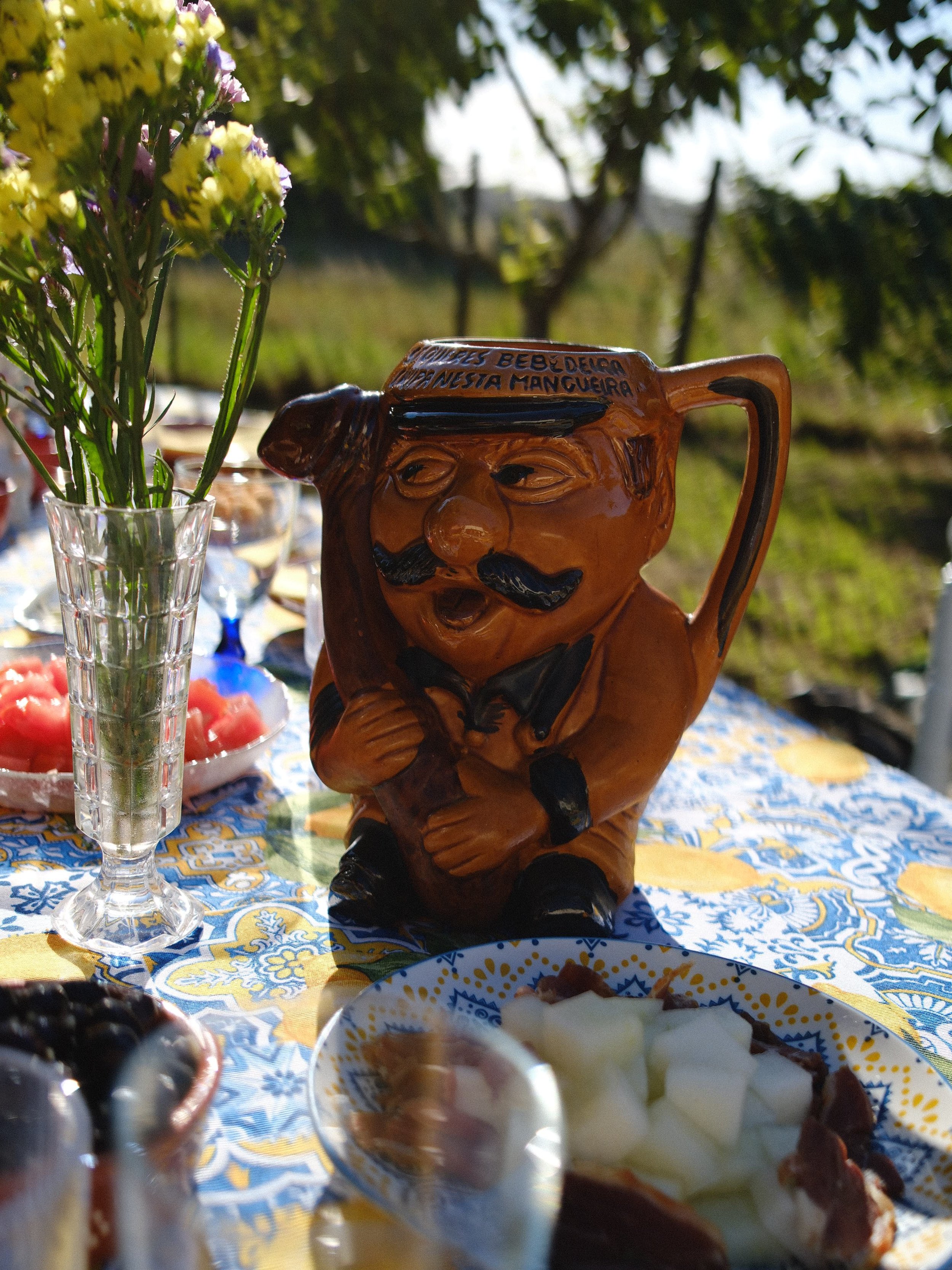 Traditional Portuguese ceramic mug featuring humorous folk art and handcrafted craftsmanship