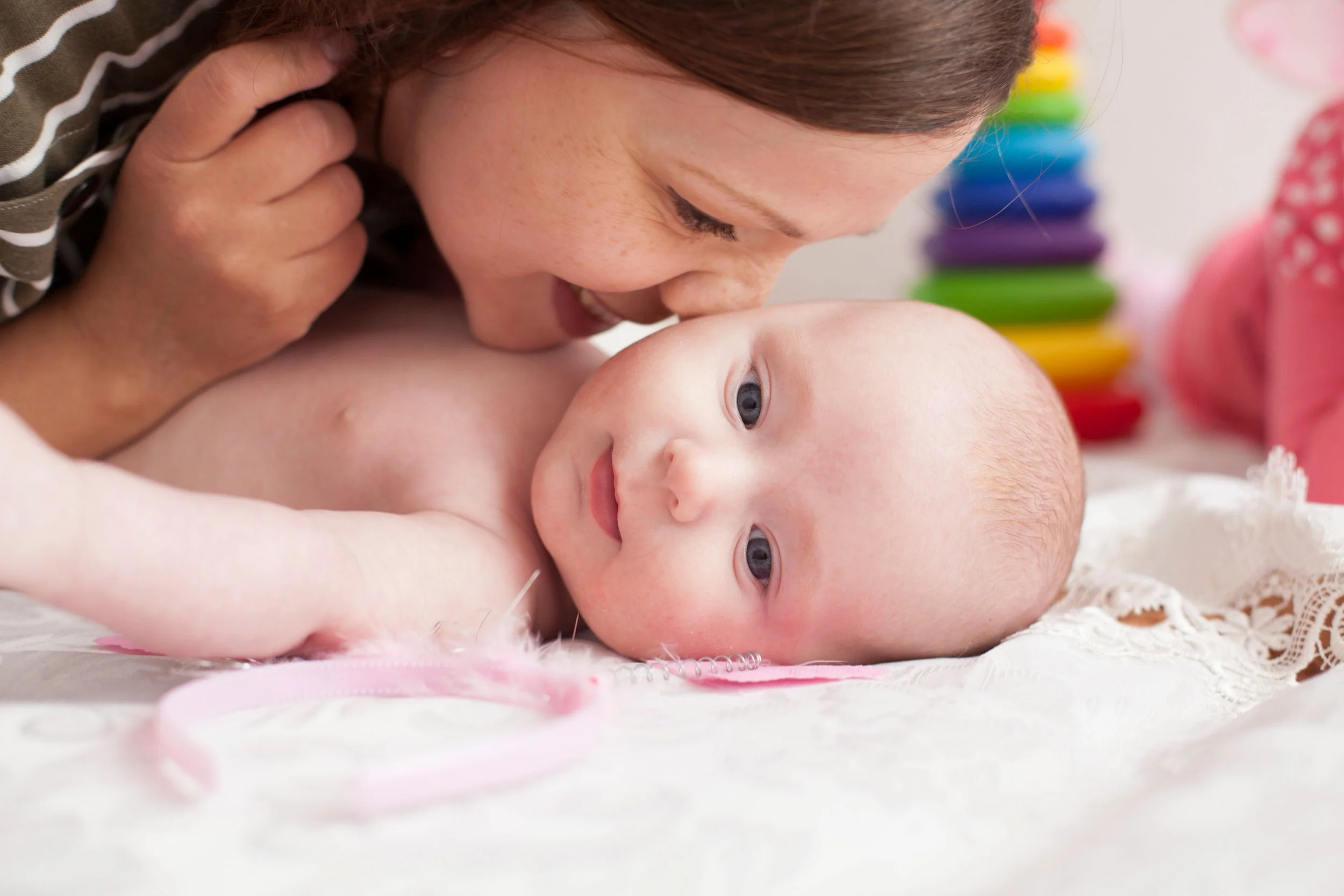 From stress to smile, a mother is enjoying engaging with her baby after an occupational therapy session.