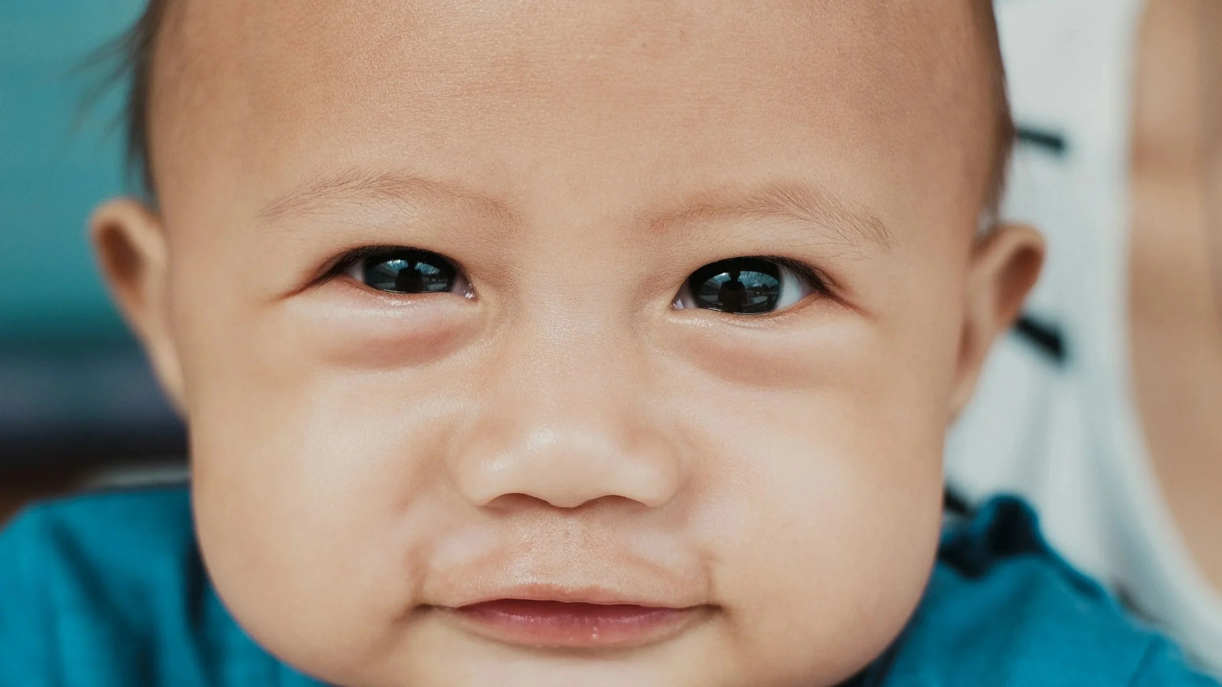 Baby's face looking at a Pediatric occupational therapist