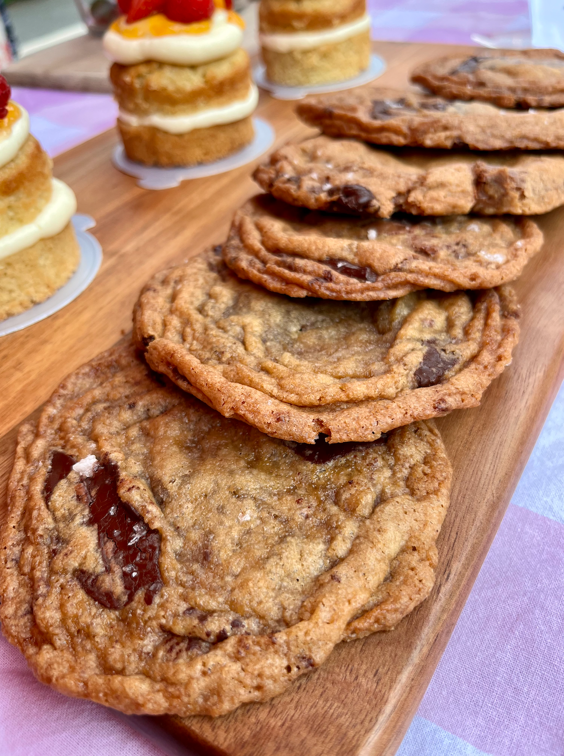 Half Moon Bay Double Chocolate Chip Cookies stacked together on a wooden board