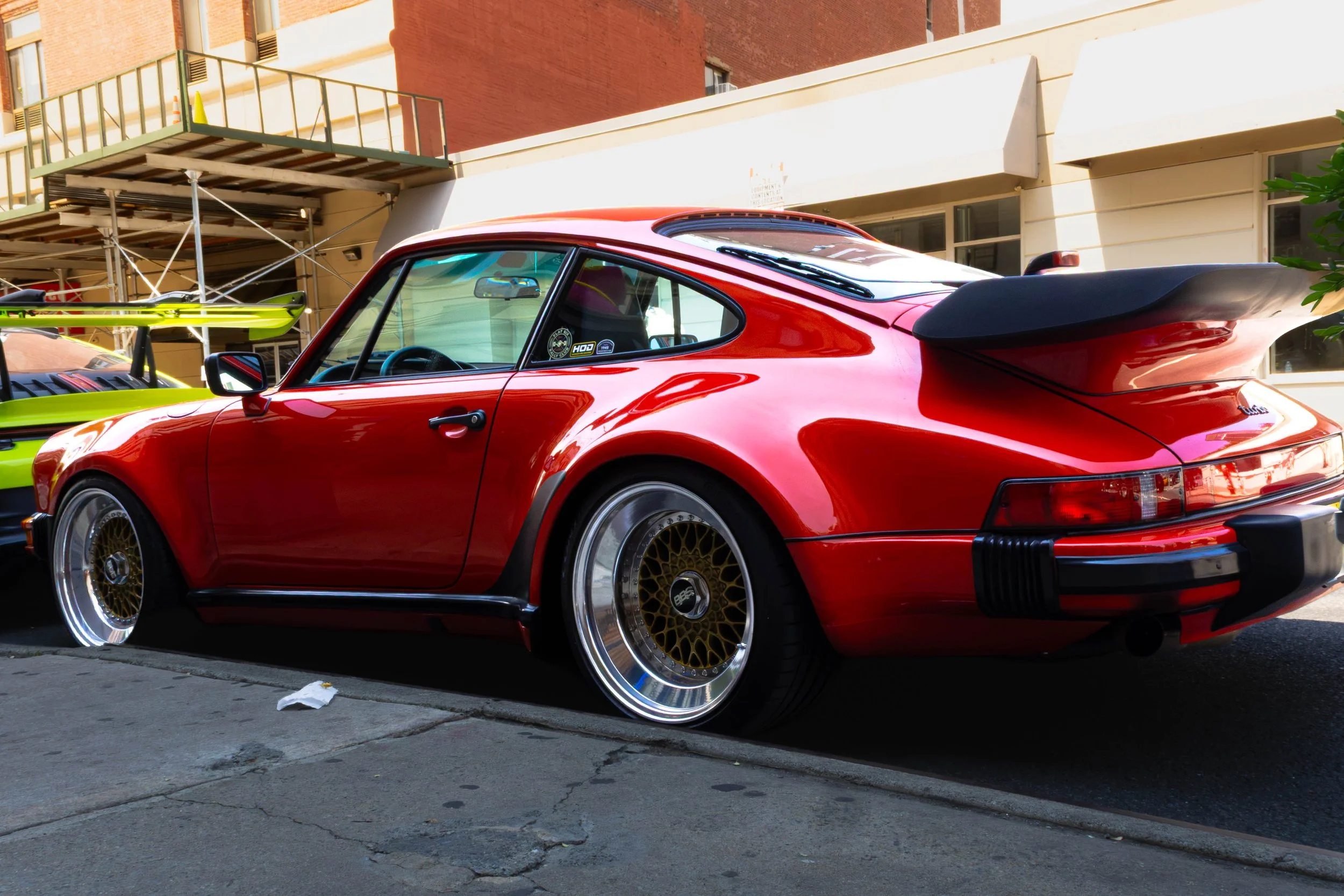 A bright red Porsche in china town, NYC.