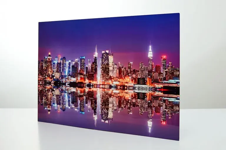 A canvas print of a city skyline at night reflected in the water.