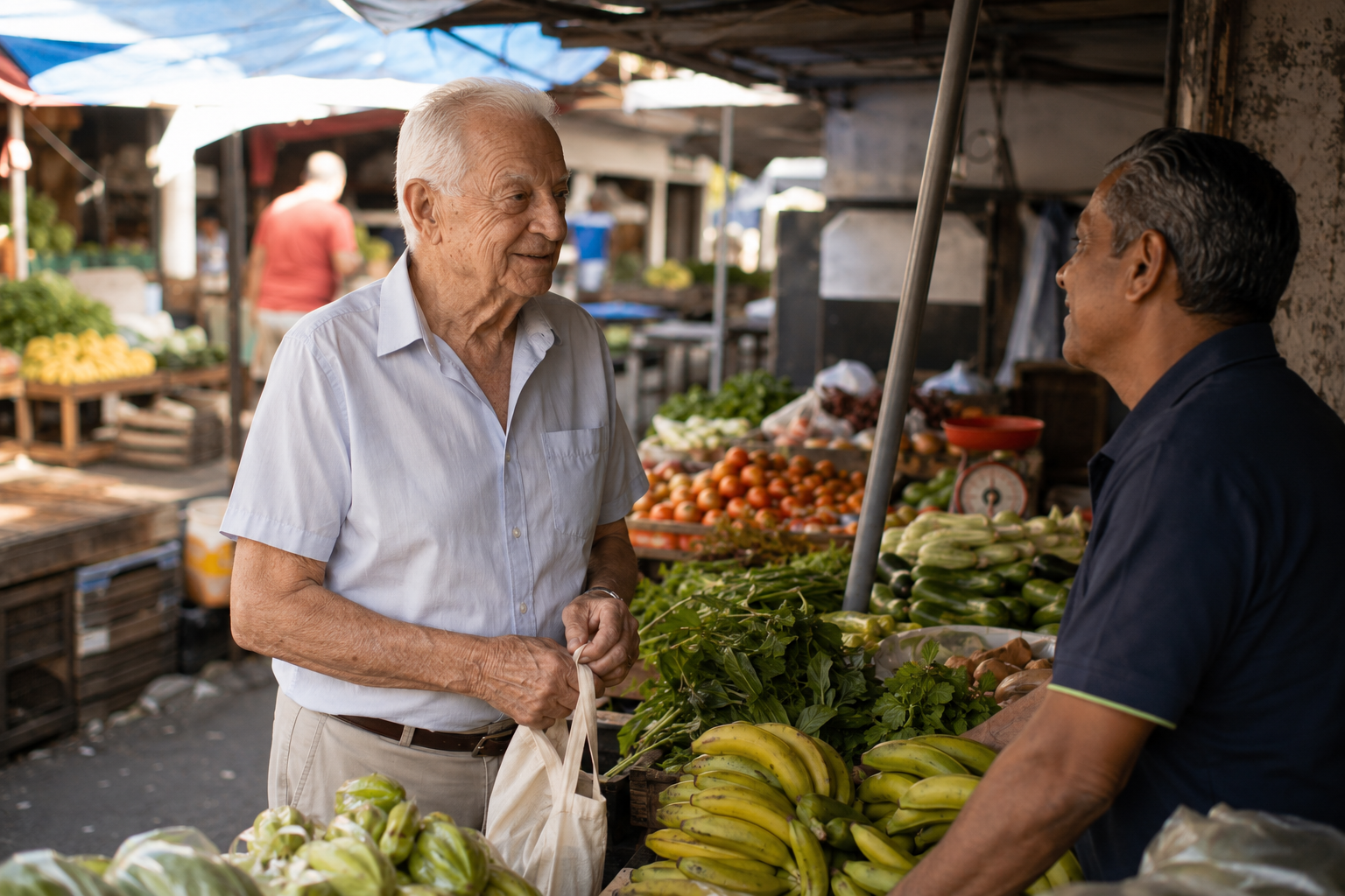 An elderly man buying vegetables and talking with the seller at a market in northern Mauritius