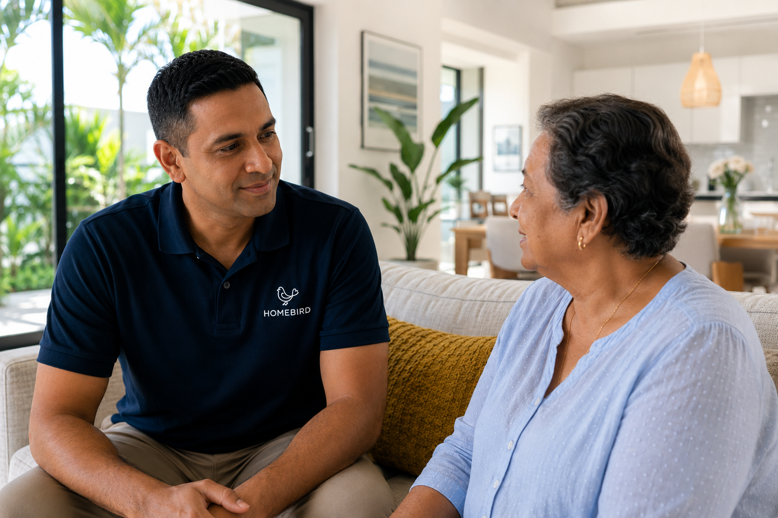 A great professional carer listening patiently to an elderly client at home in Mauritius