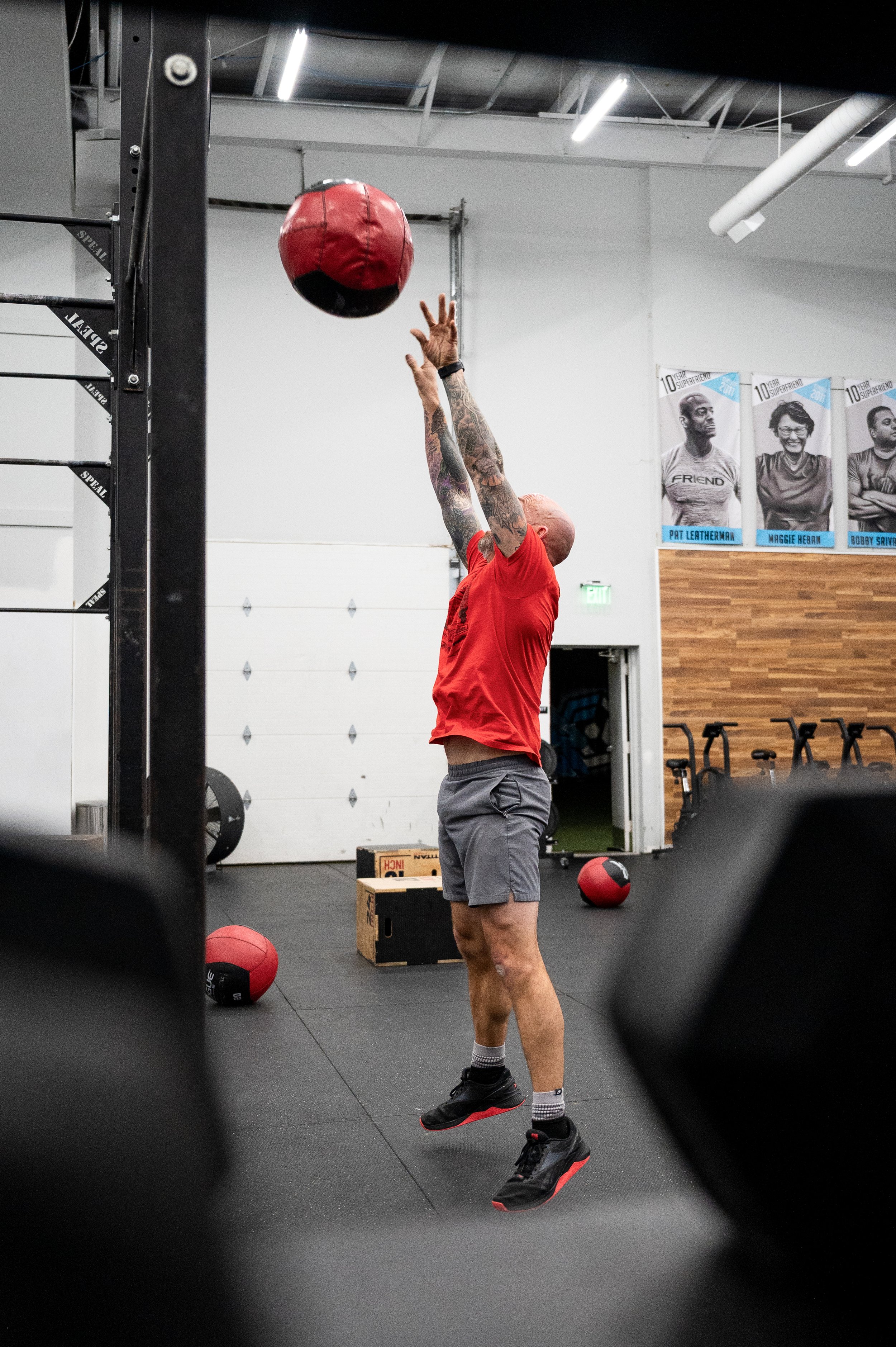 Athlete performing a medicine ball exercise during a group training session at Friendship Fitness.