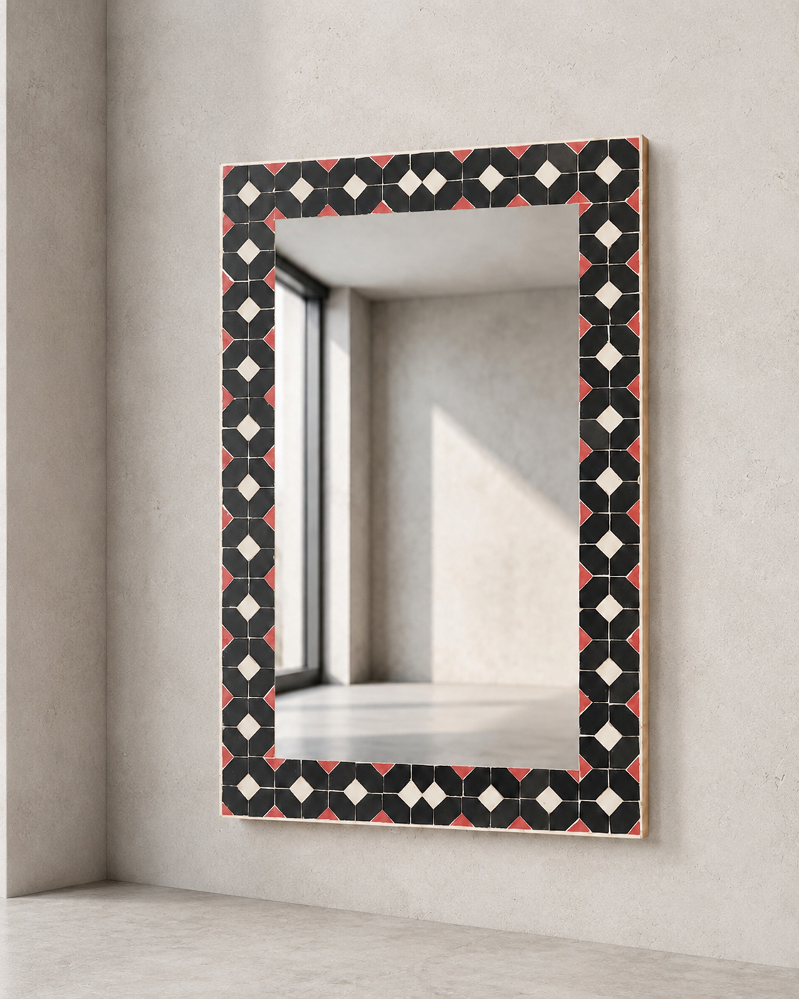 Handcrafted mosaic mirror from Tangier, Morocco, with an inlaid border in dusty rose, black and cream tones. One of a kind, with a distinctive contemporary aesthetic. Dimensions: H 61 x W 41 cm.