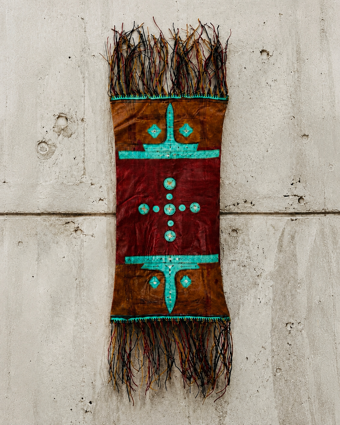 Exquisitely crafted piece of camel hide, fashioned from two layers, with fringed edges and a recessed opening at the back. Its original function is uncertain; the form suggests that it may once have served as a leather vessel or pouch. It is traditio