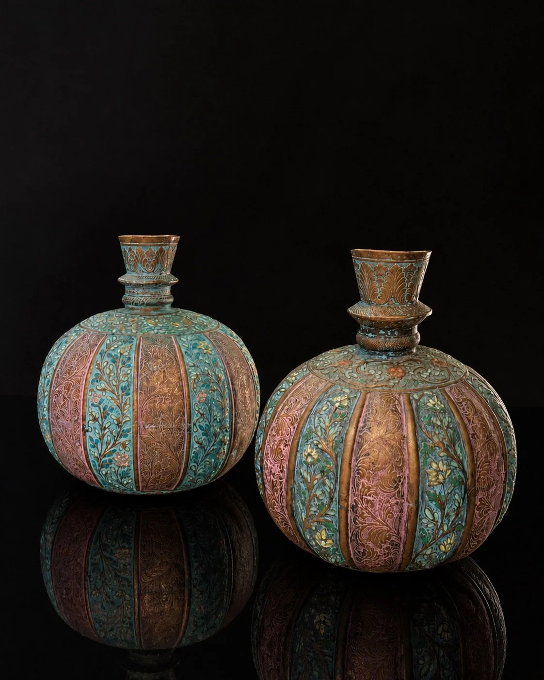 Pair of copper vessels decorated with cloisonné enamel in intricate floral and foliate patterns. Believed to be Indian and dating from the 19th century, they reflect the refined craftsmanship of traditional metalwork. Their beautifully developed pati