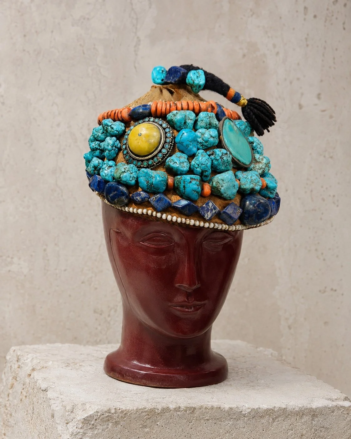 Ornate headdress discovered in Tangier, embellished with turquoise & deep blue stones, orange beads and an amber-coloured cabochon.
Heavy in the hand, the headpiece has a remarkable presence. Its generous use of stone, together with the visible wear 