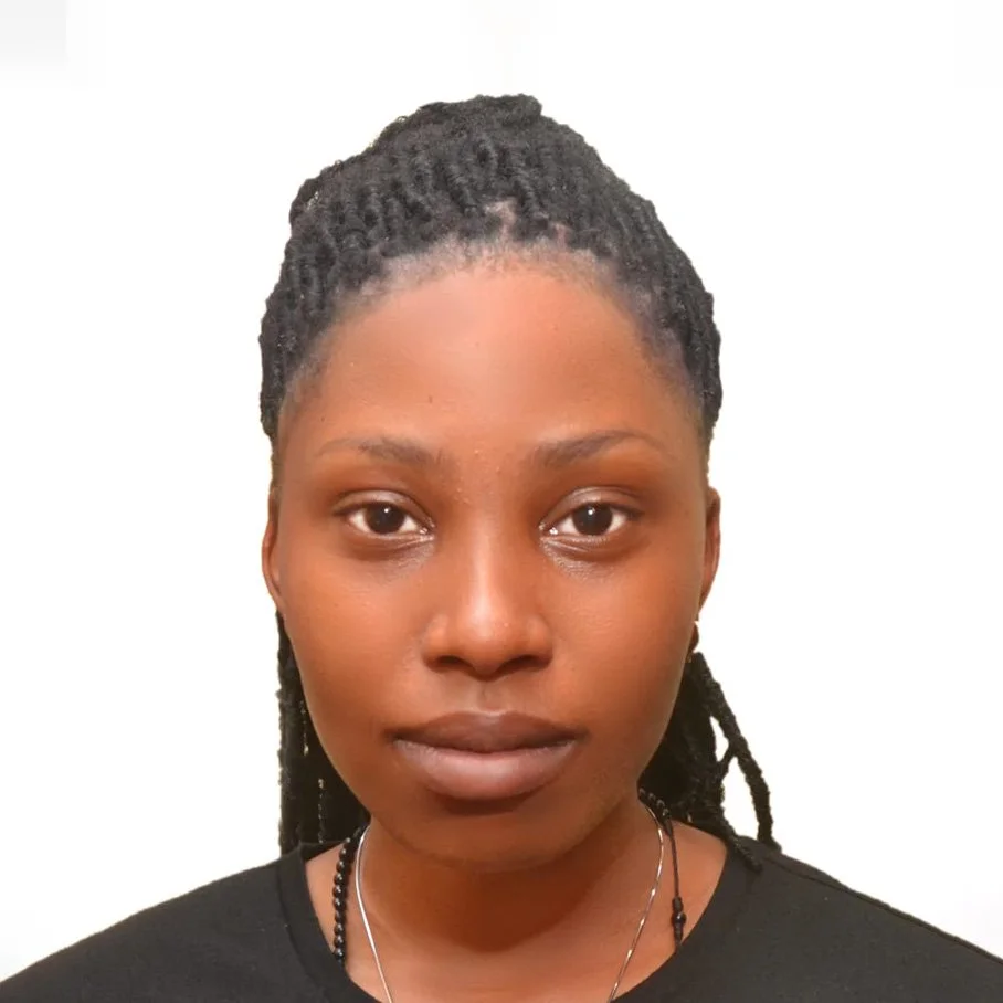 A woman with braided hair looking into the camera against a plain white background.