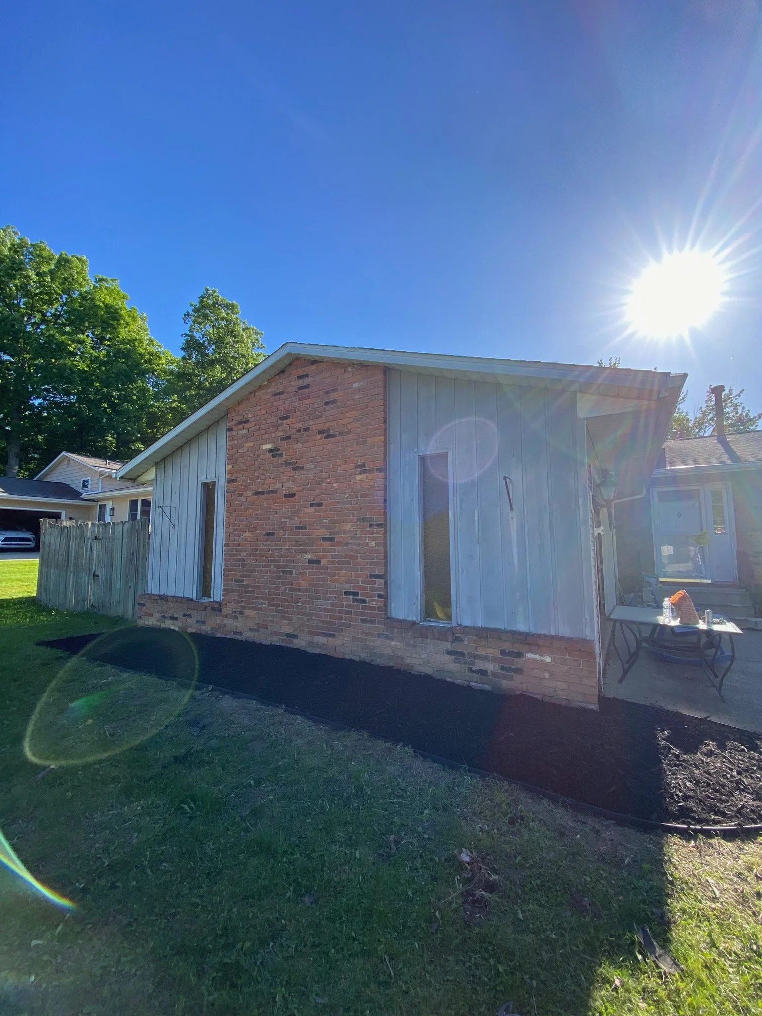 a brick house, Brunswick, Ohio, featuring neatly maintained landscaping and professional landscape installation by H&H Property Services