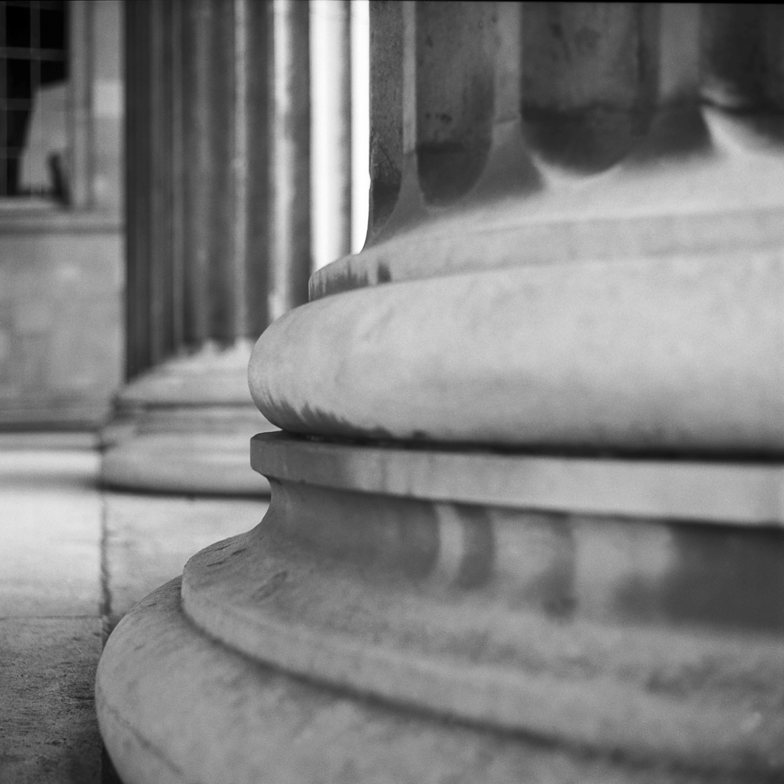Close-up black and white photo of columns. Black and white architecture photograph.