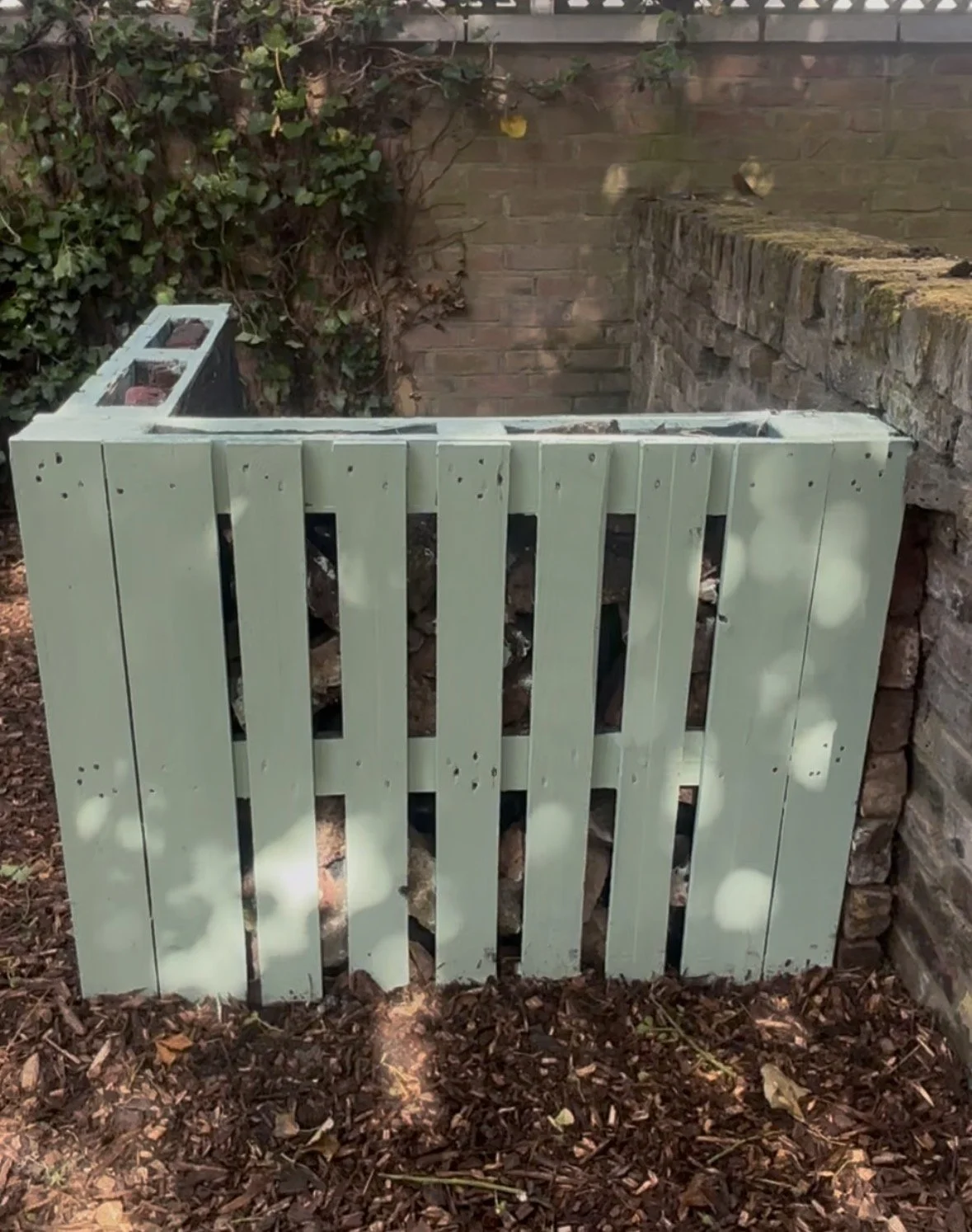 Compost area built from reclaimed pallets