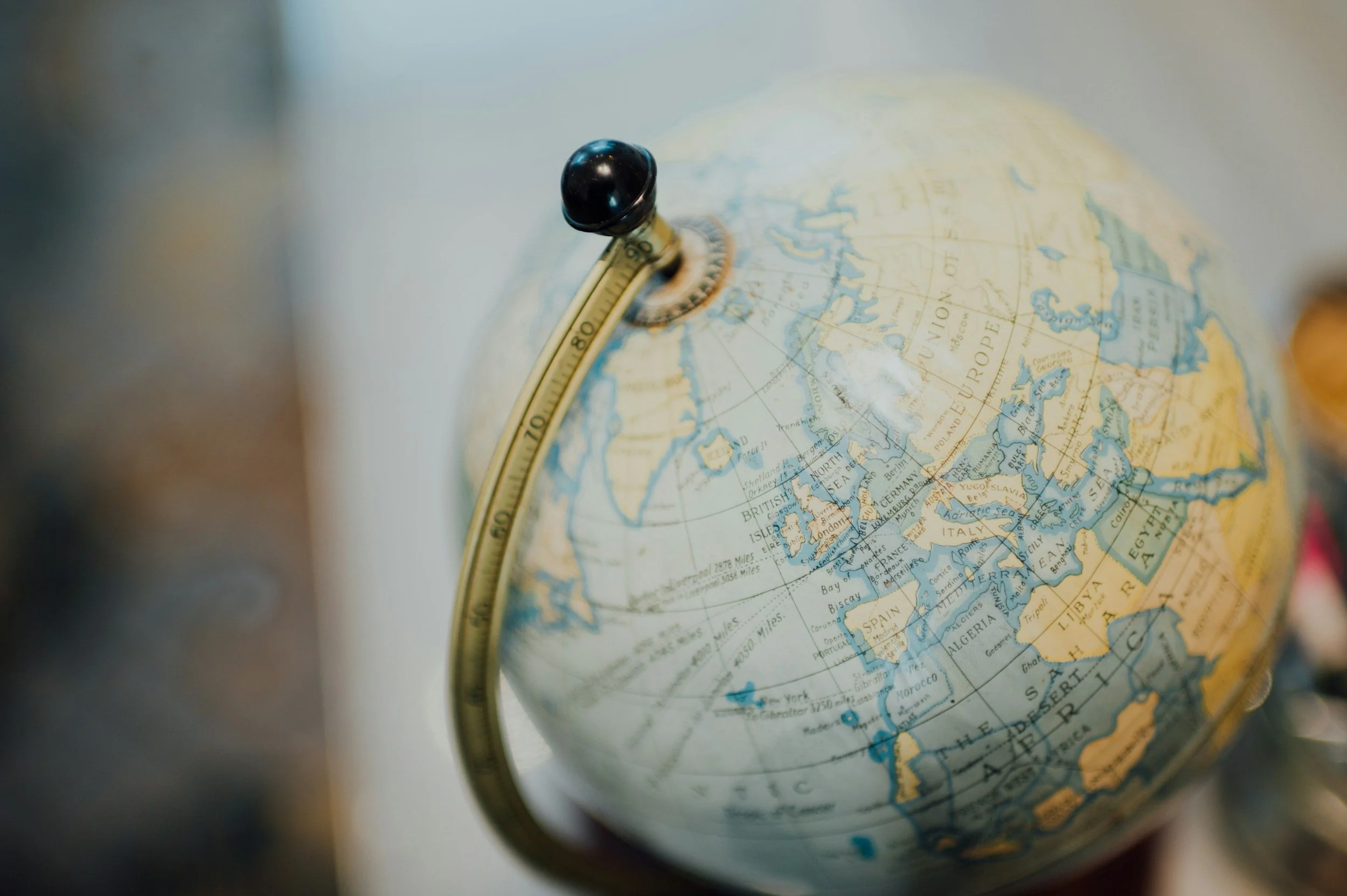 A globe showing parts of Europe, Africa, and the Middle East, with a focus on the Arctic region, featuring a black globe marker.