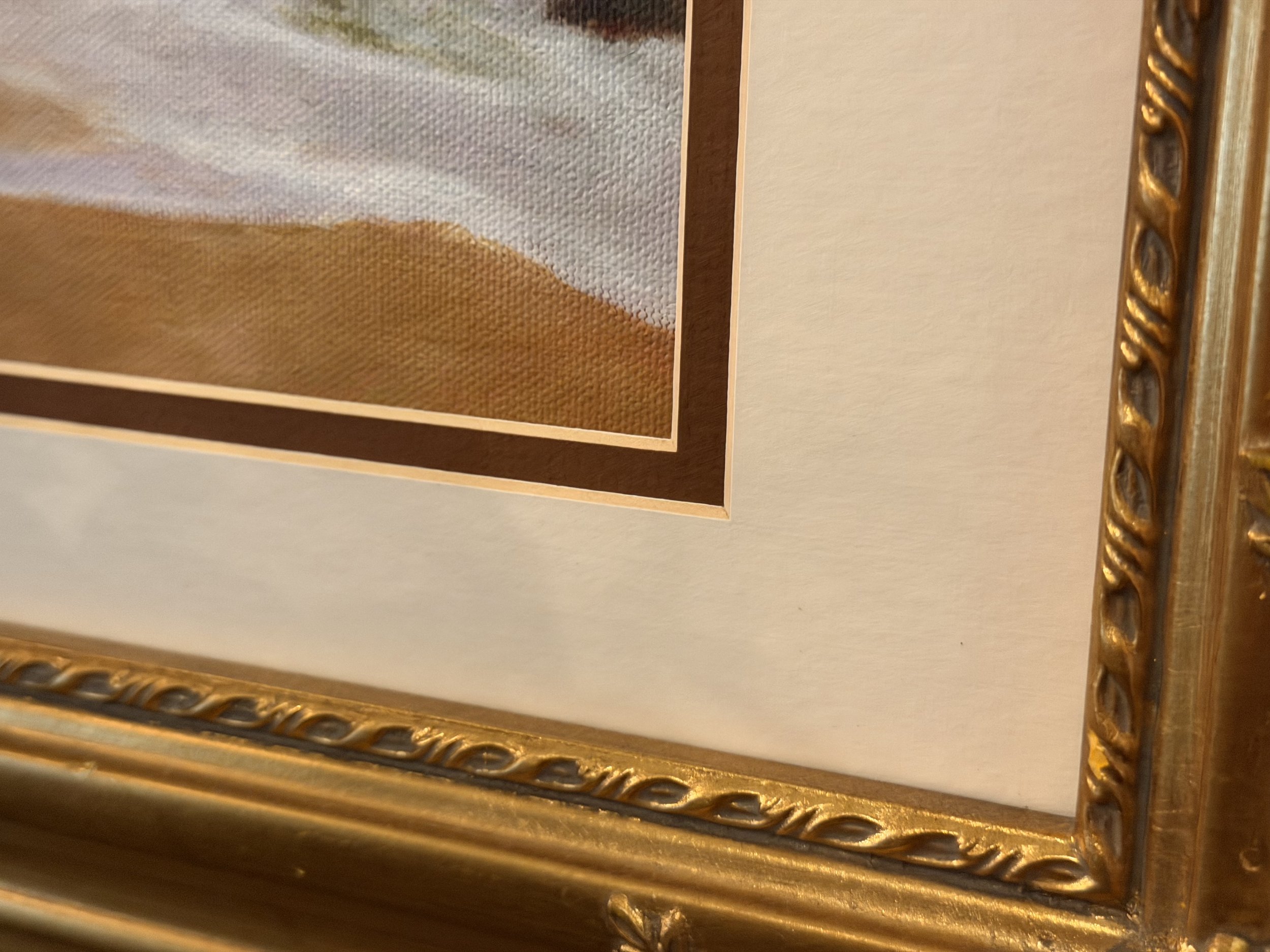 Close-up of the unsigned corner of Julie’s framed seascape painting.