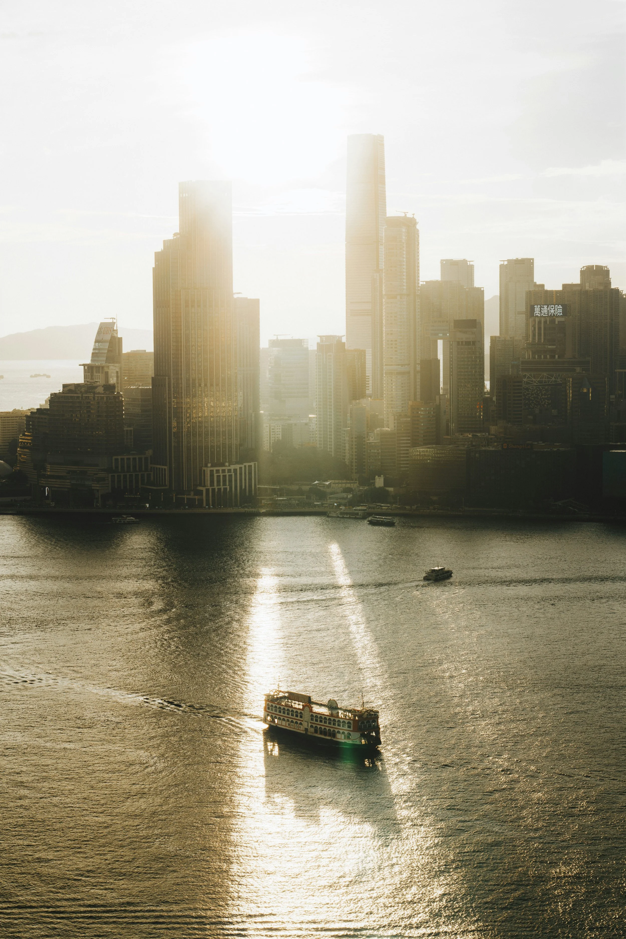 Ferry crossing San Francisco Bay in golden evening light with the city skyline in the background.