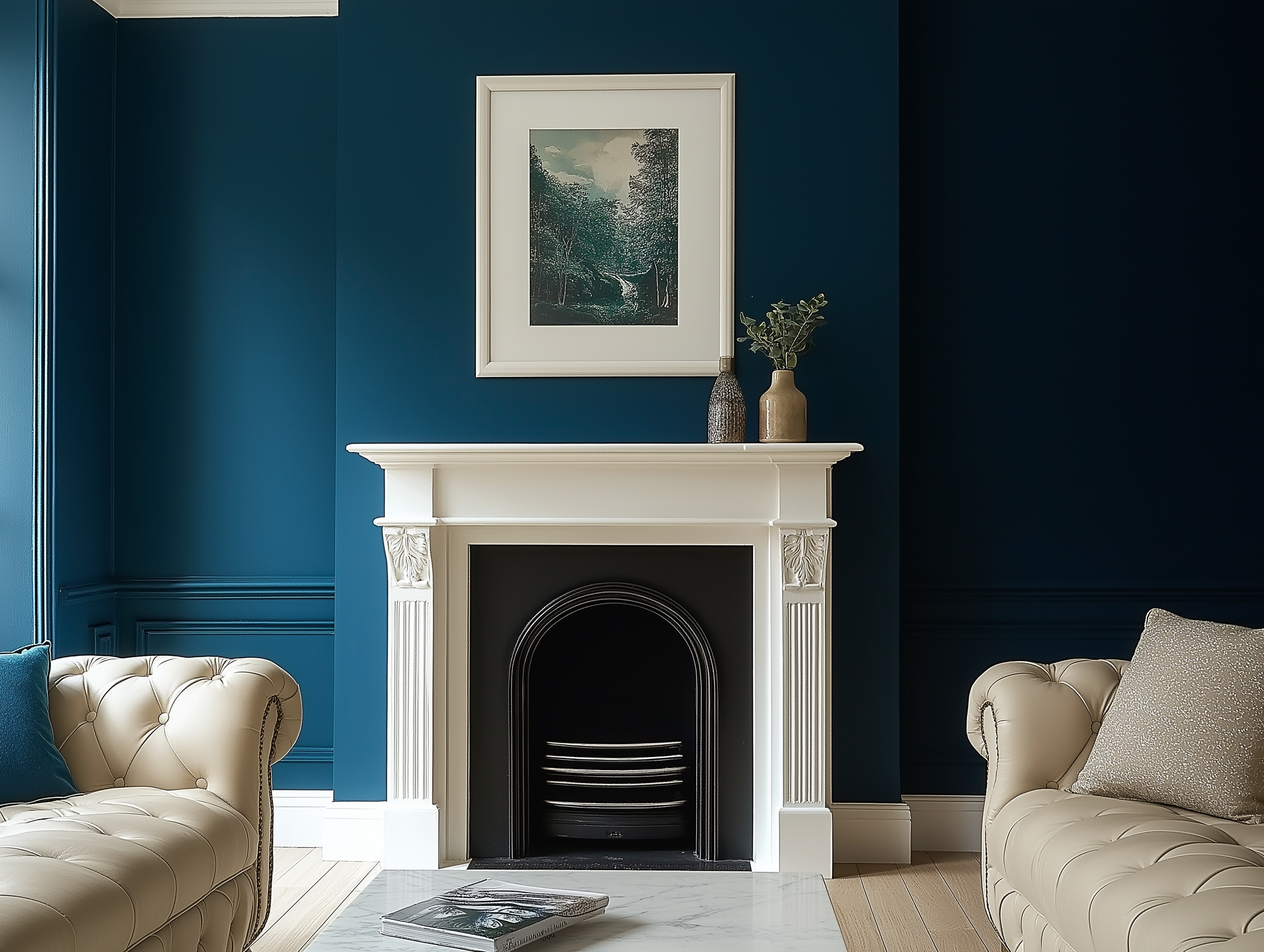 A living room featuring a deep teal accent wall, a white fireplace with classic molding, cream tufted Chesterfield sofas, and modern ceramic vases for decor.