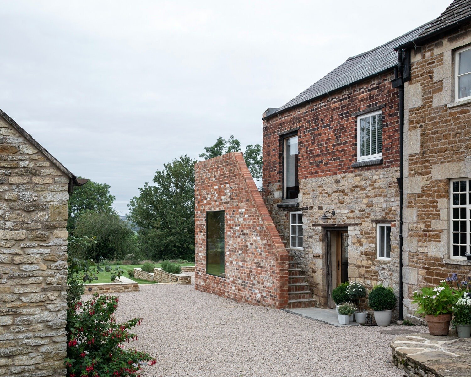 exterior parchment works brick ruins side view modern glass infill extension