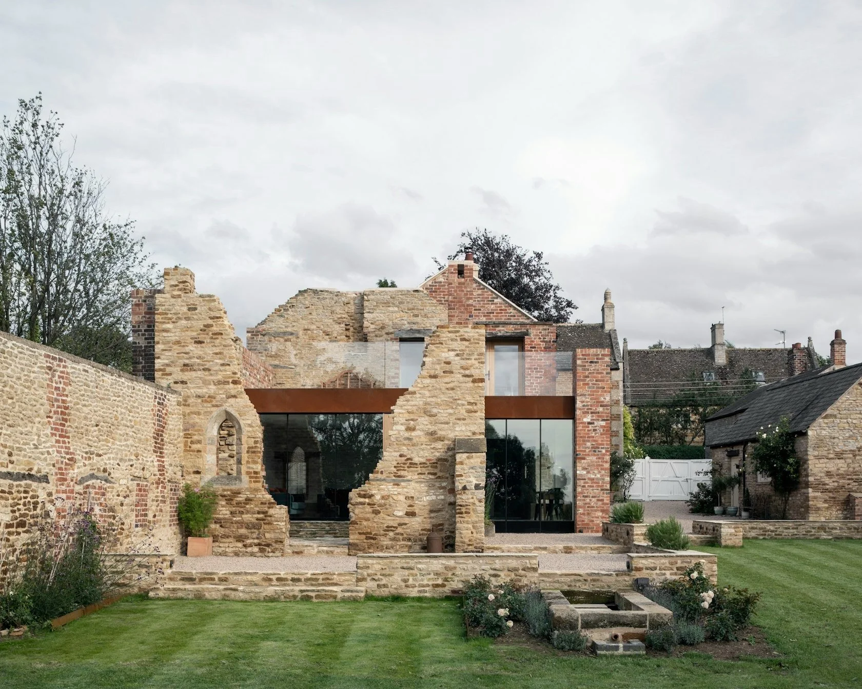 exterior parchment works brick ruins modern glass infill extension
