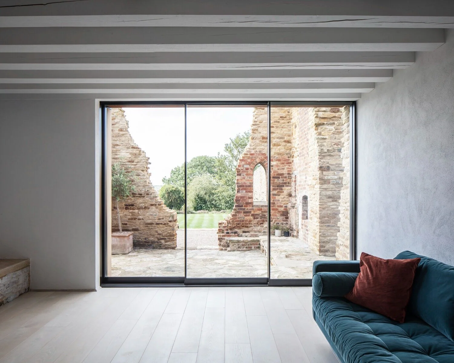 minimalist living room ruin view large windows parchment works northamptonshire