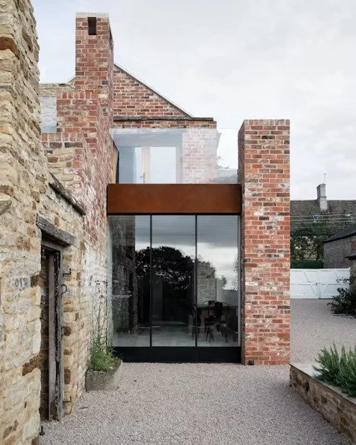 modern-glass-extension-red-brick-stone-ruins-uk-residential-design.jpg