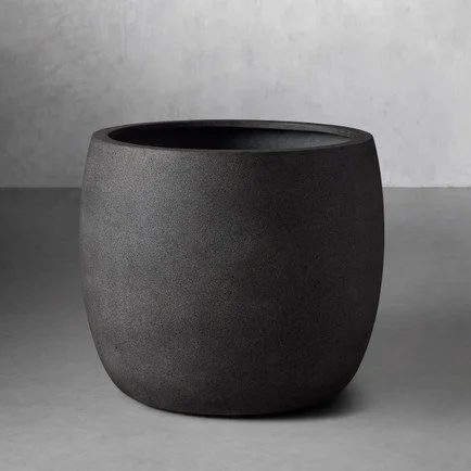 Stunning ash grey outdoor round planter set on a minimalistic grey background.