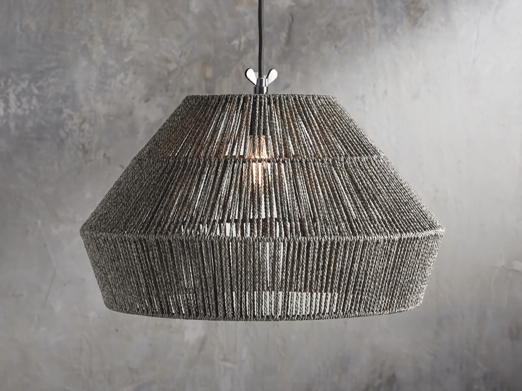 An elegant powder grey wicker light pendant hanging from the ceiling with a powder grey background.