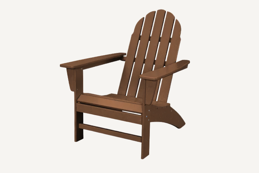 This rustic brown Vineyard Adirondack chair is an outdoor lounge chair with wide armrests, a tall slatted back, and a seat that is higher in the front than the back and is set on a neutral background.