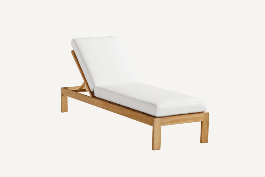 The teak chaise lounge with seat cushions and back cushions has clean lines and generously sized armrests that create a simple, yet classic look for any outdoor space. Frames are handcrafted from high-quality teak and set on a neutral background.