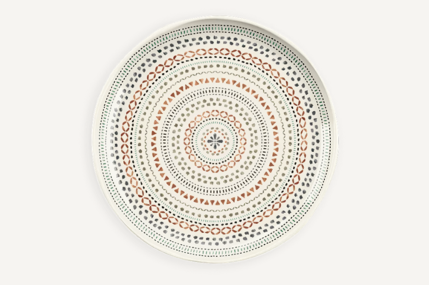 Round melamine dinner plate featuring an intricate bohemian-inspired pattern with concentric circles of geometric shapes in earthy tones of terracotta, green, and gray. The detailed design adds a stylish and eclectic touch to outdoor dining.